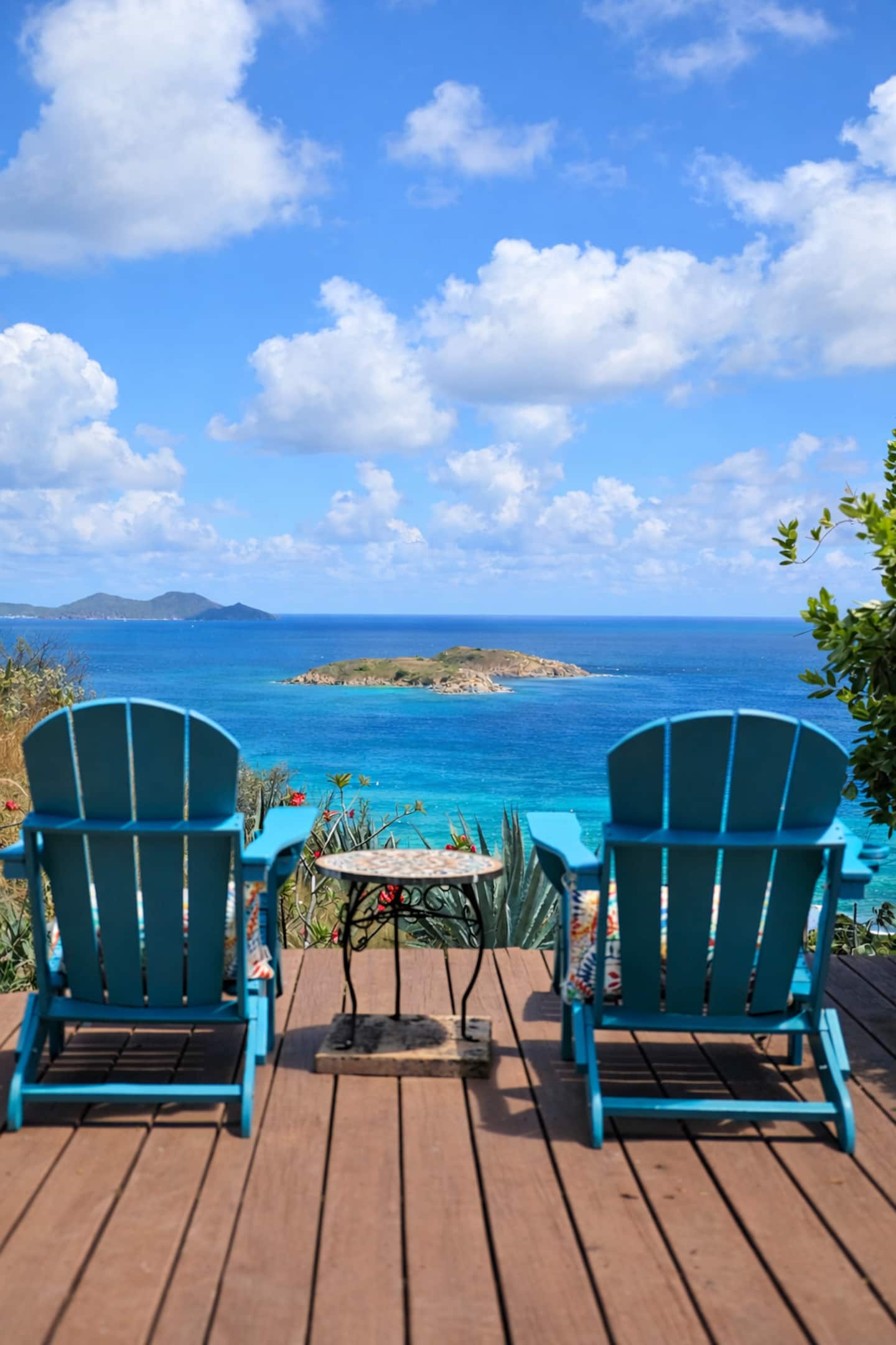 Two blue chairs overlooking the Caribbean Sea from Surf Sound Cottage