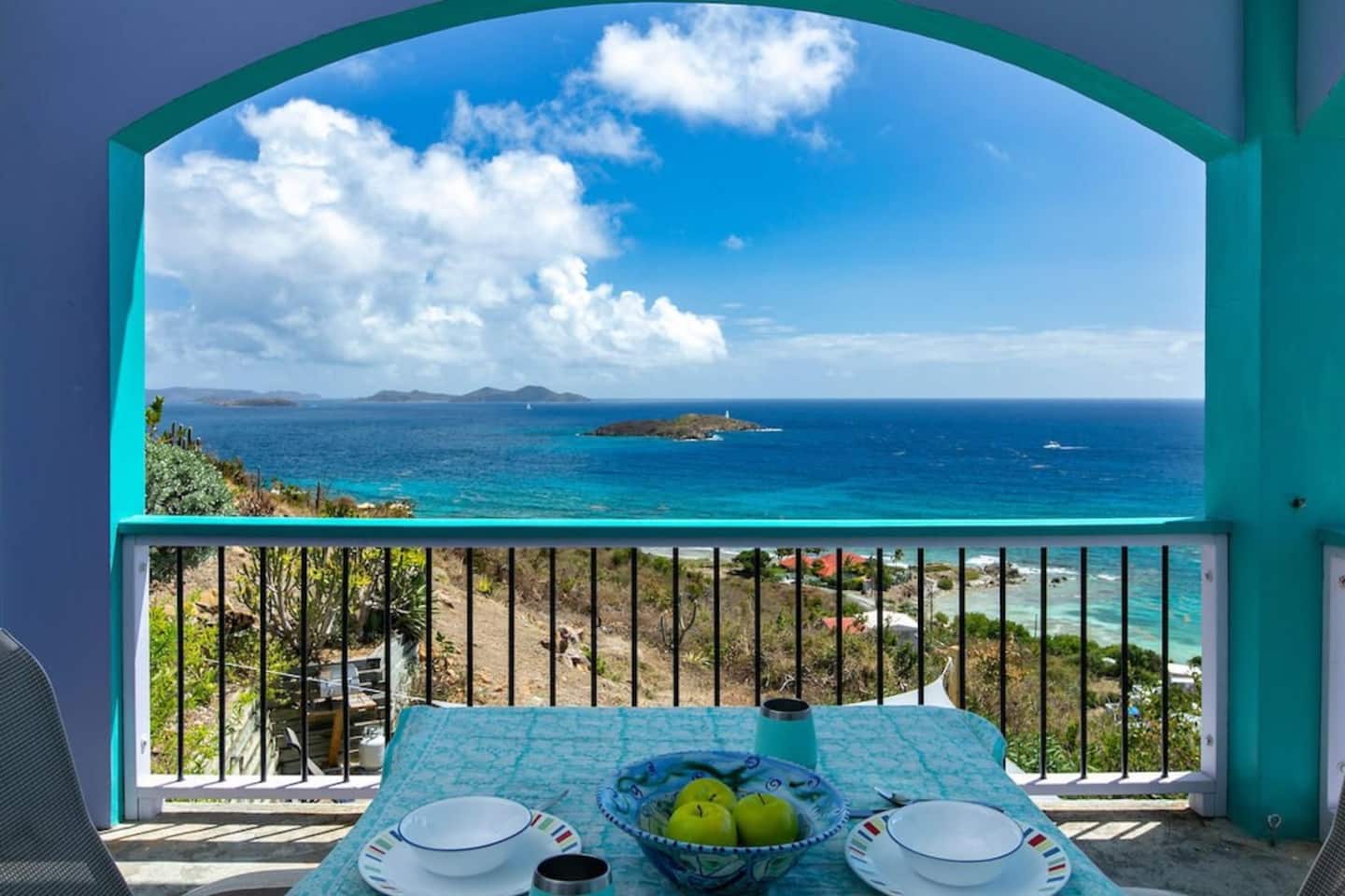 Covered dining patio framing the ocean view at Surf Sound Cottage